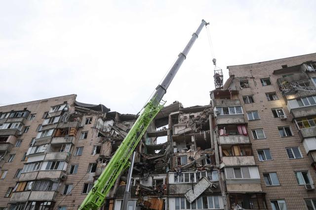 Rescuers work on a residential building partially destroyed as a result of Russian missile strike on the Ukrainian capital of Kyiv on July 6, 2026, amid the Russian invasion in Ukraine. The death toll from Russian bombardment on the Kyiv region on July 6, has risen from eight to 10, authorities said, warning the number could rise further. (Photo by Serhii Okunev / AFP)