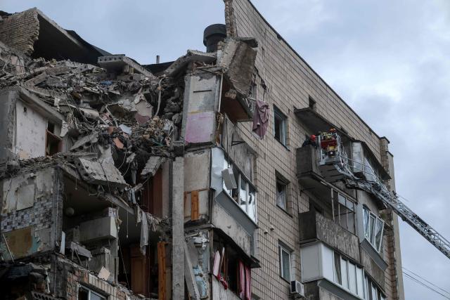 Rescuers work on a residential building partially destroyed as a result of Russian missile strike on the Ukrainian capital of Kyiv on July 6, 2026, amid the Russian invasion in Ukraine. The death toll from Russian bombardment on the Kyiv region on July 6, has risen from eight to 10, authorities said, warning the number could rise further. (Photo by Serhii Okunev / AFP)