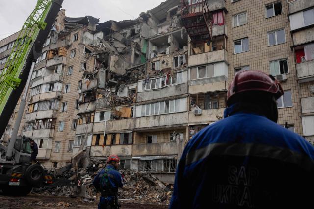 Firefighters work at the site of a damaged residential building following a Russian missile strike on the Ukrainian capital of Kyiv on July 6, 2026, amid the Russian invasion in Ukraine. The death toll from Russian bombardment on the Kyiv region on July 6, has risen from eight to 10, authorities said, warning the number could rise further. (Photo by Tetiana DZHAFAROVA / AFP)