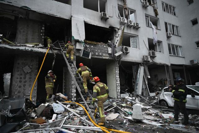 Rescuers work on a multistorey residential building, damaged following a Russian missile strike on the Ukrainian capital of Kyiv on July 6, 2026, amid the Russian invasion in Ukraine. Russia struck Kyiv's capital region with ballistic missiles on Monday, sparking fires and killing at least four people, authorities said, on the eve of a NATO summit in Ankara. (Photo by Genya Savilov / AFP)