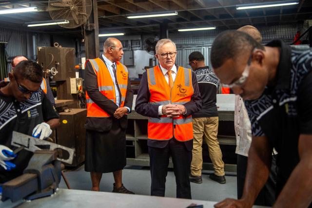 Australian Prime Minister Anthony Albanese (C) tours the Vuvale Skills hub after it's opening in Suva on July 6, 2026. Australia signed a new defence alliance with Fiji on July 6, bolstering ties with its South Pacific island neighbor as it seeks to outmanoeuvre China in the region. (Photo by LEON LORD / AFP)