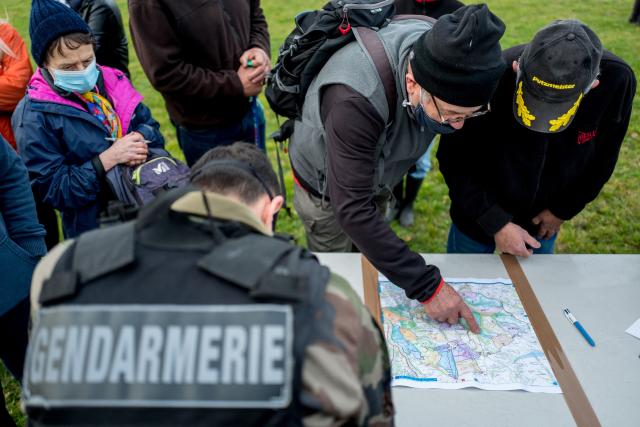 (FILES) Volunteers register with the French gendarmes to take part in the searches in the woods of Milhars, on December 23, 2020, to look for Delphine Jubillar, a woman missing since December 15, in Cagnac, les Mines near Albi, in the southern France. While he had denied any involvement, Cedric Jubillar has admitted to killing his wife Delphine, missing in the Tarn region since late 2020, a change of defense strategy coming two months before his appeal trial, this revelation having being recorded in a handwritten letter addressed to his lawyer Pierre Debuisson to which La Depeche du Midi had access. (Photo by Fred SCHEIBER / AFP)