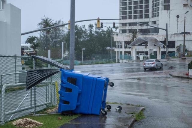 A dumpster is seen overturned after strong winds brought by Super Typhoon Bavi in Guam on July 6, 2026. A "super typhoon" with the force of a category-five hurricane tore through the US Pacific territories of Northern Marianas and Guam on July 6, with authorities saying they had received reports of "major" damage on the small island of Rota. (Photo by Yuichi YAMAZAKI / AFP)