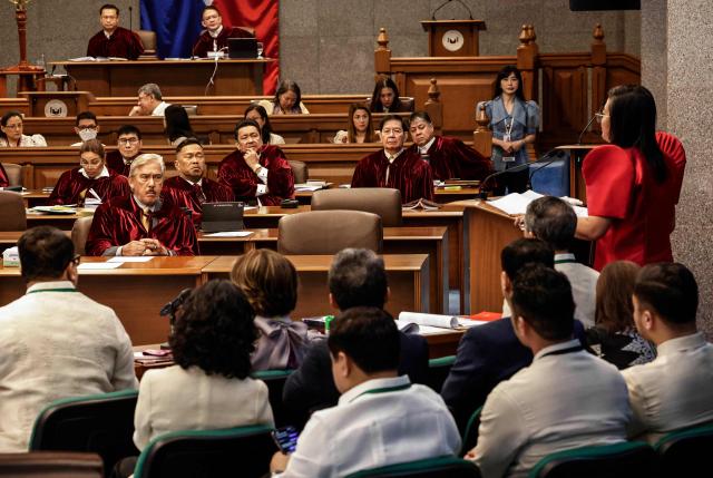 Philippine senators acting as judges of the impeachment court listen to Philippine Congresswoman Gerville Luistro (standing R), a member of the prosecution panel, delivering an opening statement during proceedings for the impeachment trial of Philippine Vice-President Sara Duterte at the Philippine Senate in Pasay City, Metro Manila on July 6, 2026. The Philippine Senate opened Vice President Sara Duterte's impeachment trial on July 6, with her political career -- and a planned 2028 presidential run -- in the balance. (Photo by Rolex DELA PENA / POOL / AFP)