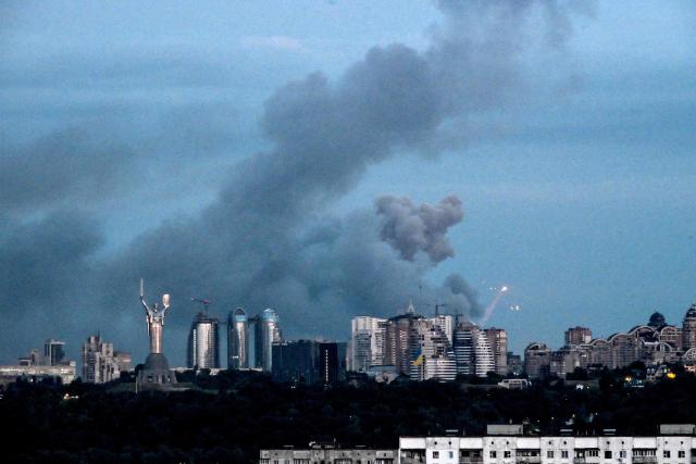 This photograph shows smoke rising during Russian missile strikes on the Ukrainian capital of Kyiv on July 6, 2026, amid the Russian invasion in Ukraine. Russia fired missiles and drones into apartment buildings in Kyiv for the second time in a week on Monday morning, killing at least 14 people on the eve of a crucial NATO summit, authorities said. (Photo by Evgen KOTENKO / AFP)