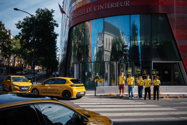 Activists gather holding placards which read as 'No to Police's license to kill' and 'When the police kill, who is held accountable' during a symbolic action by Amnesty International against the criminal justice and victim respect bill at the Ministry of the Interior branch in Paris on July 6, 2026. The bill on the presumption of self-defense for law enforcement, which is due to be debated on July 7, 2026 at the National Assembly, risks creating a "license to kill" and a form of blanket immunity for police officers and gendarmes, human rights defenders warn. (Photo by Dimitar DILKOFF / AFP)