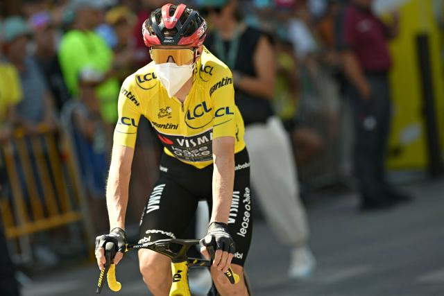 Team Visma | Lease a Bike's Danish rider Jonas Vingegaard wearing the overall leader's yellow jersey and a protective face mask awaits the start of the 3rd stage of the 113th edition of the Tour de France cycling race, 196 km between Granollers and Les Angles in southern France, on July 6, 2026. (Photo by Loic VENANCE / AFP)