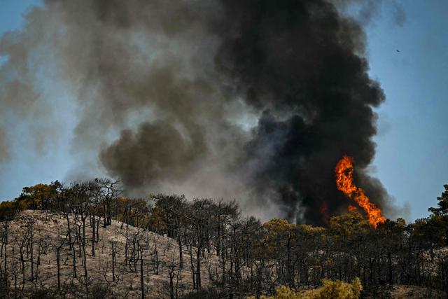 A wildfire rages on a hill in the southern France departmennt of Herault as 700 hundred firefighters backed by special aircraft battled to control a "gigantic" blaze in nearby department of Pyrenees-Orientales, near the town of Carlencas-et-Levas on July 6, 2026. Wildfires raged across southern Europe, forcing thousands of people to evacuate their homes and prompting officials to ban spectators from a stage of the storied Tour de France cycling race. (Photo by Gabriel BOUYS / AFP)