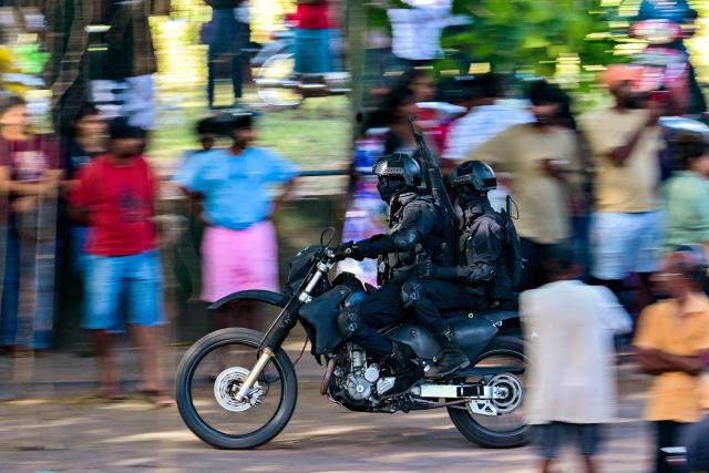 Military personnel patrol outside the Negombo prison on the outskirts of Colombo on July 6, 2026, following overnight clashes between inmates of two drug gangs. Clashes in a Sri Lankan jail have killed at least 19 people, including four guards, in the worst prison riot in more than five years, officials said on July 6. (Photo by Ishara S. KODIKARA / AFP)