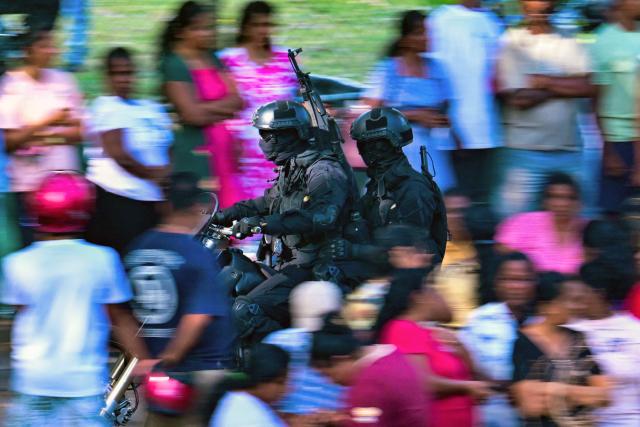 Military personnel patrol outside the Negombo prison on the outskirts of Colombo on July 6, 2026, following overnight clashes between inmates of two drug gangs. Clashes in a Sri Lankan jail have killed at least 19 people, including four guards, in the worst prison riot in more than five years, officials said on July 6. (Photo by Ishara S. KODIKARA / AFP)