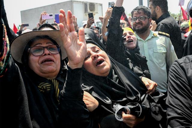 Mourners react during the funeral procession for Iran's slain Supreme Leader Ali Khamenei near Azadi Square in Tehran on July 6, 2026. Massive crowds are expected on July 6 for the funeral procession of late Iranian supreme leader Ali Khamenei in Tehran, with authorities hoping to avoid a repeat of the chaos that accompanied his predecessor's funeral. (Photo by Wakil Kohsar / AFP) / 