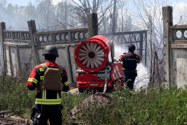 Firefighters work to extinguish a fire at a destroyed residential area in Vyshneve, Kyiv suburb, following a Russian missile strike on the Ukrainian capital of Kyiv on July 6, 2026, amid the Russian invasion of Ukraine. Officials in the Kyiv suburb of Vyshneve said they were evacuating residents due to the possibility of unexploded munitions in the debris. (Photo by Serhii Okunev / AFP)