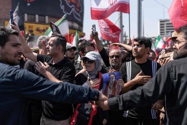 Mourners react as they gather along a street during the funeral procession of Iran's slain supreme leader Ali Khamenei and his family members, in Tehran July 6, 2026. Vast crowds gathered for the funeral procession of Iran's slain supreme leader Ali Khamenei in Tehran on July 6, with authorities estimating millions were on the streets in numbers that could rival those of his predecessor's farewell nearly four decades ago. (Photo by AFP) / 