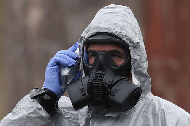 (FILES) A member of the military speaks on a device wearing protective coveralls as he works to remove vehicles from a cordoned off area behind a police station in Salisbury, southern England, on March 11, 2018, as investigations and operations continue in connection with the major incident sparked after a man and a woman were apparently poisoned in a nerve agent attack. Britain on Monday, July 6, unveiled sanctions against seven Russian scientists and two research labs said to have helped develop chemical weapons used in two attacks. The sanctions target those involved in developing the Novichok nerve agent used in a 2018 attack on a former Russian spy hiding in England and a chemical believed to have fatally poisoned Russian opposition activist Alexei Navalny in Siberia in 2024. (Photo by Daniel LEAL / AFP)