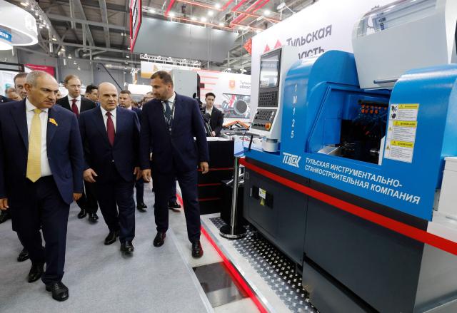 In this pool photograph distributed by the Russian state agency Sputnik, Russia's Prime Minister Mikhail Mishustin and Armenian Prime Minister Nikol Pashinyan tour the Innoprom 2026 international industrial exhibition in Yekaterinburg on July 6, 2026. (Photo by Dmitry ASTAKHOV / POOL / AFP)