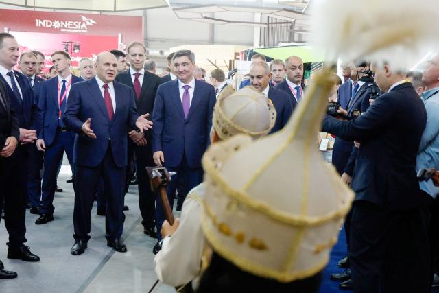 In this pool photograph distributed by the Russian state agency Sputnik, Russia's Prime Minister Mikhail Mishustin and Armenian Prime Minister Nikol Pashinyan tour the Innoprom 2026 international industrial exhibition in Yekaterinburg on July 6, 2026. (Photo by Dmitry ASTAKHOV / POOL / AFP)