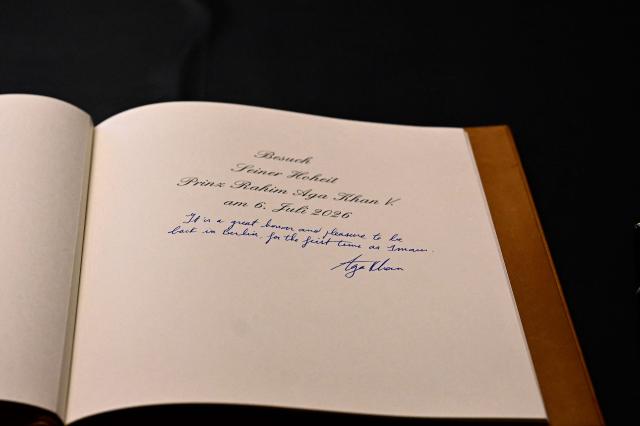 The entry in the German President's guest book shows the entry of Prince Rahim al-Hussaini, Aga Khan V, the 50th hereditary Imam of the Nizari Isma'ili Shia Islam, during a visit on July 6, 2026 in Berlin. (Photo by Tobias SCHWARZ / AFP)