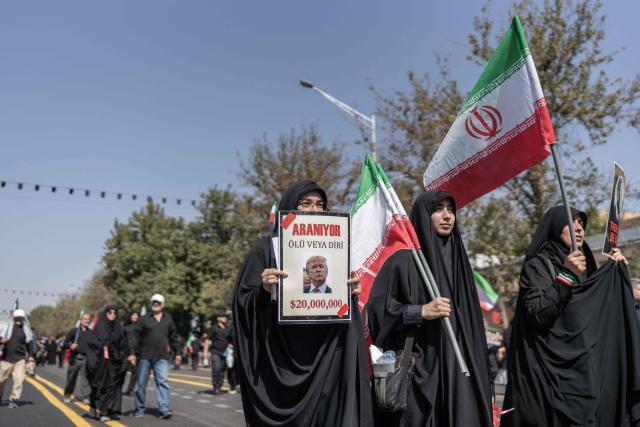 Mourners hold Iranian national flags and placards with anti-US slogans as people attend the funeral pocession of Iran's slain supreme leader Ayatollah Ali Khamenei and his family members in Tehran on July 6, 2026. Vast crowds gathered for the funeral procession of Iran's slain supreme leader Ali Khamenei in Tehran on July 6, with authorities estimating millions were on the streets in numbers that could rival those of his predecessor's farewell nearly four decades ago. (Photo by AFP) / 