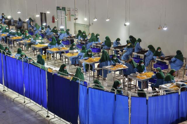 Afghan women work at a dry fruit factory in Mazar-i-Sharif on July 6, 2026. Afghanistan needs the talents of both women and men to respond to major challenges as millions return to the country grappling with a severe humanitarian crisis, two UN officials said July 6. (Photo by Atif ARYAN / AFP)