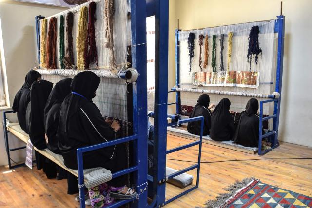 Afghan women work at a carpet factory in the Nahr-e-shahi district of Afghanistan's Balkh province on July 6, 2026. Afghanistan needs the talents of both women and men to respond to major challenges as millions return to the country grappling with a severe humanitarian crisis, two UN officials said July 6. (Photo by Atif ARYAN / AFP)