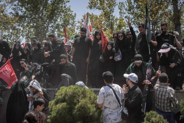 Mourners attend the funeral procession of Iran's slain supreme leader Ali Khamenei and his family members, along a street in Tehran July 6, 2026. Vast crowds gathered for the funeral procession of Iran's slain supreme leader Ali Khamenei in Tehran on July 6, with authorities estimating millions were on the streets in numbers that could rival those of his predecessor's farewell nearly four decades ago. (Photo by AFP) / 