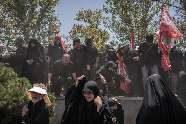 Mourners attend the funeral procession of Iran's slain supreme leader Ali Khamenei and his family members, along a street in Tehran July 6, 2026. Vast crowds gathered for the funeral procession of Iran's slain supreme leader Ali Khamenei in Tehran on July 6, with authorities estimating millions were on the streets in numbers that could rival those of his predecessor's farewell nearly four decades ago. (Photo by AFP) / 