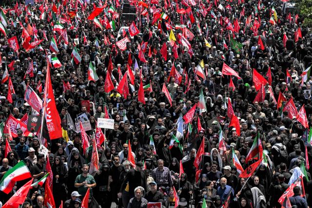 Mourners march towards Azadi Square in Tehran on July 6, 2026 during a funeral procession for Iran's slain supreme leader Ali Khamenei and his family members. Massive crowds are expected on July 6 for the funeral procession of late Iranian supreme leader Ali Khamenei in Tehran, with authorities hoping to avoid a repeat of the chaos that accompanied his predecessor's funeral. (Photo by Wakil Kohsar / AFP) / 