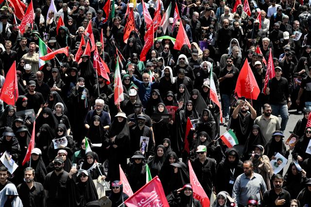 Mourners march towards Azadi Square in Tehran on July 6, 2026 during a funeral procession for Iran's slain supreme leader Ali Khamenei and his family members. Massive crowds are expected on July 6 for the funeral procession of late Iranian supreme leader Ali Khamenei in Tehran, with authorities hoping to avoid a repeat of the chaos that accompanied his predecessor's funeral. (Photo by Wakil Kohsar / AFP) / 