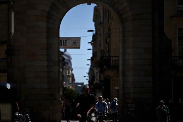 Cyclists ride through the Vieux Bordeaux area (Old Bordeaux) in Bordeaux, south-western France on July 6, 2026, as France experiences another heatwave. (Photo by Christophe ARCHAMBAULT / AFP)