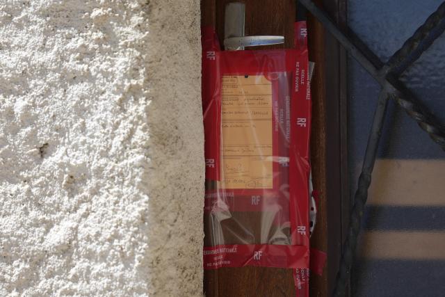 This photograph shows a view of Jerome Barella's house door with a judicial seal amid a search conducted at the home of murder suspect Jerome Barella in Montestruc-sur-Gers, southwestern France, on July 6, 2026, as part of the investigation into the disappearance and death of 11-year-old Lyhanna. The death and rape of Lyhanna, an 11-year-old middle school student who went missing in late May before being found dead on June 4 in the Gers, has stirred a wave of anger and emotion across the country, with an inspection mission concluding there were failures in the justice system. (Photo by Valentine CHAPUIS / AFP)