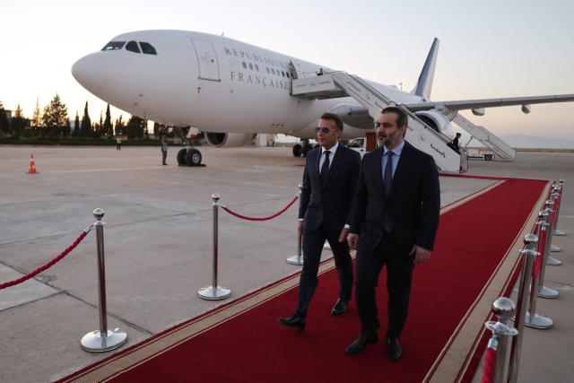 France's President Emmanuel Macron (L) is welcomed by Syria's Foreign Minister Asaad al-Shaibani (R) as he arrives fo a state visit at the Damascus International Airport in Damascus on July 6, 2026. French President Emmanuel Macron arrived in Damascus on July 6, 2026 for the first visit by a Western European head of state since Syria's new authorities took power in 2024, an AFP journalist said. Macron, who will depart on July 7, 2026, will advocate for "a free, pluralist Syria that respects each of its components" and plays a role in moderating Middle East tensions, the French presidency told journalists ahead of his arrival. (Photo by Ludovic MARIN / AFP)