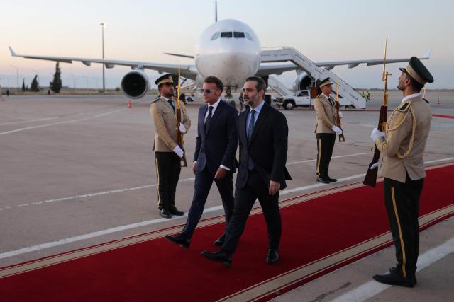 France's President Emmanuel Macron (L) is welcomed by Syria's Foreign Minister Asaad al-Shaibani (R) as he arrives fo a state visit at the Damascus International Airport in Damascus on July 6, 2026. French President Emmanuel Macron arrived in Damascus on July 6, 2026 for the first visit by a Western European head of state since Syria's new authorities took power in 2024, an AFP journalist said. Macron, who will depart on July 7, 2026, will advocate for "a free, pluralist Syria that respects each of its components" and plays a role in moderating Middle East tensions, the French presidency told journalists ahead of his arrival. (Photo by Ludovic MARIN / AFP)