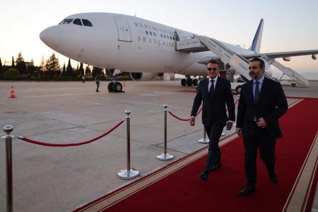 France's President Emmanuel Macron (L) is welcomed by Syria's Foreign Minister Asaad al-Shaibani (R) as he arrives fo a state visit at the Damascus International Airport in Damascus on July 6, 2026. French President Emmanuel Macron arrived in Damascus on July 6, 2026 for the first visit by a Western European head of state since Syria's new authorities took power in 2024, an AFP journalist said. Macron, who will depart on July 7, 2026, will advocate for "a free, pluralist Syria that respects each of its components" and plays a role in moderating Middle East tensions, the French presidency told journalists ahead of his arrival. (Photo by Ludovic MARIN / AFP)