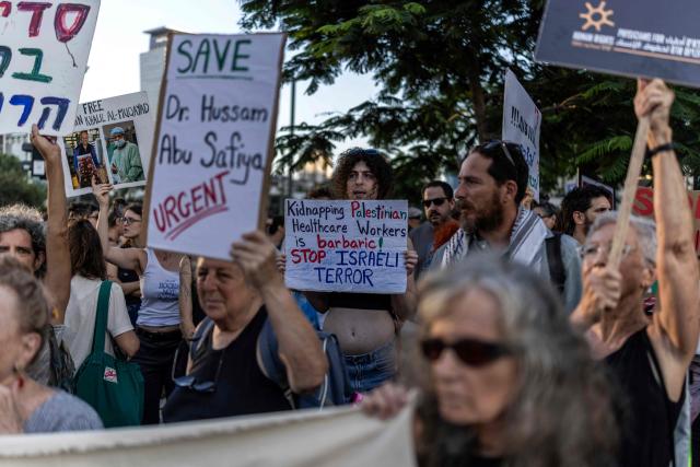 Israeli left wing activist hold placards and chant slogans in Tel Aviv on July 6, 2026, during a rally calling for release of Palestinian Gaza Doctor Hussan Abu Safiya, detained by Israeli forces since December 2024. Last month, Israel's Supreme Court struck down a government ban preventing International Committee of the Red Cross (ICRC) delegates from visiting Palestinian detainees in Israeli prisons, prompting calls on June 4 to resume such visits. (Photo by ilia YEFIMOVICH / AFP)