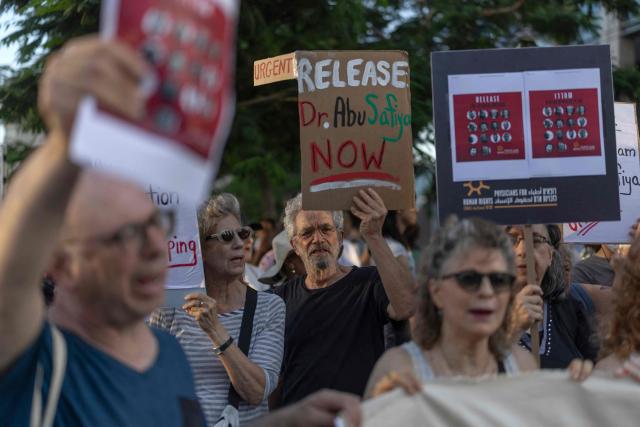 Israeli left wing activist hold placards and chant slogans in Tel Aviv on July 6, 2026, during a rally calling for release of Palestinian Gaza Doctor Hussan Abu Safiya, detained by Israeli forces since December 2024. Last month, Israel's Supreme Court struck down a government ban preventing International Committee of the Red Cross (ICRC) delegates from visiting Palestinian detainees in Israeli prisons, prompting calls on June 4 to resume such visits. (Photo by ilia YEFIMOVICH / AFP)