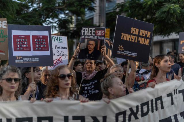 Israeli left wing activist hold placards and chant slogans in Tel Aviv on July 6, 2026, during a rally calling for release of Palestinian Gaza Doctor Hussan Abu Safiya, detained by Israeli forces since December 2024. Last month, Israel's Supreme Court struck down a government ban preventing International Committee of the Red Cross (ICRC) delegates from visiting Palestinian detainees in Israeli prisons, prompting calls on June 4 to resume such visits. (Photo by ilia YEFIMOVICH / AFP)