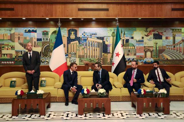 France's President Emmanuel Macron (2nd L) speaks with Syria's Foreign Minister Asaad al-Shaibani (C-R) next to France's Foreign Affairs Minister Jean-Noel Barrot (L) during a bilateral meeting at the Damascus International Airport in Damascus on July 6, 2026. French President Emmanuel Macron arrived in Damascus on July 6, 2026 for the first visit by a Western European head of state since Syria's new authorities took power in 2024, an AFP journalist said. Macron, who will depart on July 7, 2026, will advocate for "a free, pluralist Syria that respects each of its components" and plays a role in moderating Middle East tensions, the French presidency told journalists ahead of his arrival. (Photo by Ludovic MARIN / AFP)