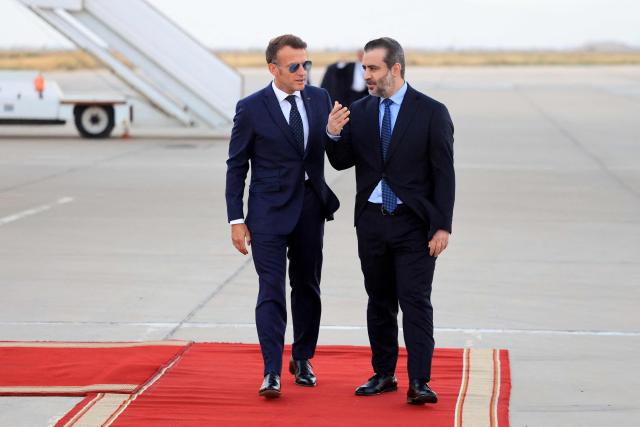 France's President Emmanuel Macron (L) is welcomed by Syria's Foreign Minister Asaad al-Shaibani (R) as he arrives for a state visit at the Damascus International Airport in Damascus on July 6, 2026. French President Emmanuel Macron arrived in Damascus on July 6, 2026 for the first visit by a Western European head of state since Syria's new authorities took power in 2024, an AFP journalist said. Macron, who will depart on July 7, 2026, will advocate for "a free, pluralist Syria that respects each of its components" and plays a role in moderating Middle East tensions, the French presidency told journalists ahead of his arrival. (Photo by Ludovic MARIN / AFP)