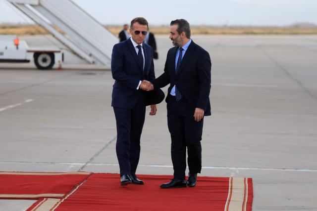 France's President Emmanuel Macron (L) is welcomed by Syria's Foreign Minister Asaad al-Shaibani (R) as he arrives for a state visit at the Damascus International Airport in Damascus on July 6, 2026. French President Emmanuel Macron arrived in Damascus on July 6, 2026 for the first visit by a Western European head of state since Syria's new authorities took power in 2024, an AFP journalist said. Macron, who will depart on July 7, 2026, will advocate for "a free, pluralist Syria that respects each of its components" and plays a role in moderating Middle East tensions, the French presidency told journalists ahead of his arrival. (Photo by Ludovic MARIN / AFP)