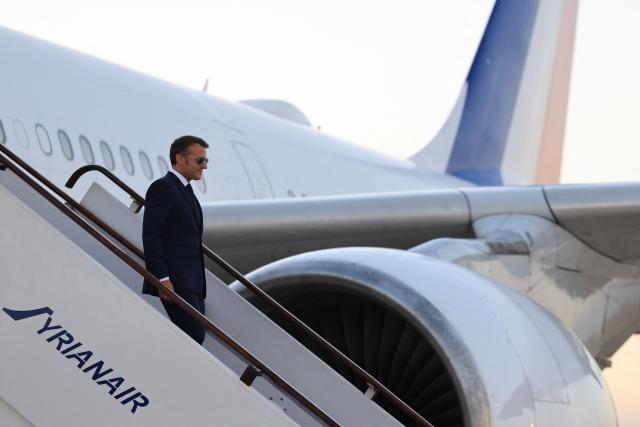 France's President Emmanuel Macron disembarks from his plane upon arrival at the Damascus International Airport for a state visit, in Damascus on July 6, 2026. French President Emmanuel Macron arrived in Damascus on July 6, 2026 for the first visit by a Western European head of state since Syria's new authorities took power in 2024, an AFP journalist said. Macron, who will depart on July 7, 2026, will advocate for "a free, pluralist Syria that respects each of its components" and plays a role in moderating Middle East tensions, the French presidency told journalists ahead of his arrival. (Photo by Ludovic MARIN / AFP)