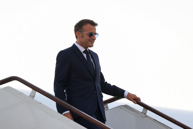 France's President Emmanuel Macron disembarks from his plane upon arrival at the Damascus International Airport for a state visit, in Damascus on July 6, 2026. French President Emmanuel Macron arrived in Damascus on July 6, 2026 for the first visit by a Western European head of state since Syria's new authorities took power in 2024, an AFP journalist said. Macron, who will depart on July 7, 2026, will advocate for "a free, pluralist Syria that respects each of its components" and plays a role in moderating Middle East tensions, the French presidency told journalists ahead of his arrival. (Photo by Ludovic MARIN / AFP)