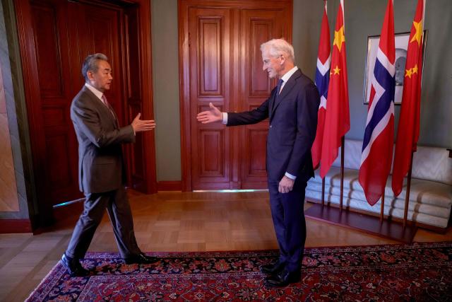Chinese Foreign Minister Wang Yi (L) and Norwegian Prime Minister Jonas Gahr Store meet at the Prime Minister's Residence in Oslo, Norway on July 6, 2026. (Photo by Javad Parsa / NTB / AFP) / Norway OUT
