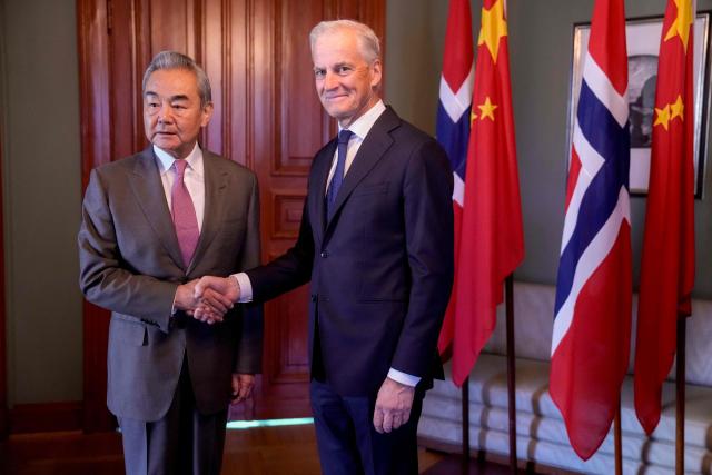 Chinese Foreign Minister Wang Yi (L) and Norwegian Prime Minister Jonas Gahr Store shake hands at the Prime Minister's Residence in Oslo, Norway on July 6, 2026. (Photo by Javad Parsa / NTB / AFP) / Norway OUT