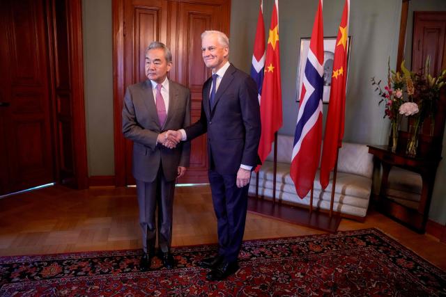 Chinese Foreign Minister Wang Yi (L) and Norwegian Prime Minister Jonas Gahr Store shake hands at the Prime Minister's Residence in Oslo, Norway on July 6, 2026. (Photo by Javad Parsa / NTB / AFP) / Norway OUT