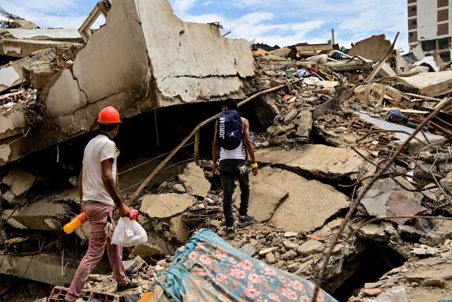 Residents search for missing family members amid the rubble of collapsed buildings in the Caribe sector of Caraballeda, La Guaira state, Venezuela, on July 6, 2026, following powerful earthquakes that struck the region. The earthquakes that struck Venezuela on June 24 have claimed the lives of at least 3,342 people, the Venezuelan government reported on July 5. (Photo by MARTIN BERNETTI / AFP)