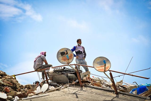 Residents search for missing family members amid the rubble of collapsed buildings in the Caribe sector of Caraballeda, La Guaira state, Venezuela, on July 6, 2026, following powerful earthquakes that struck the region. The earthquakes that struck Venezuela on June 24 have claimed the lives of at least 3,342 people, the Venezuelan government reported on July 5. (Photo by MARTIN BERNETTI / AFP)