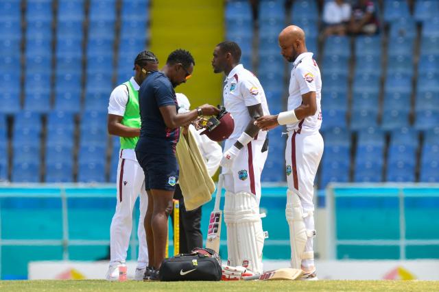Physiotherapist Dr. Denis Byam (L) checks West Indies' Roston Chase's (R) helmet after being hit by Asitha Fernando of Sri Lanka during the 4th day of the 2nd Test between Sri Lanka and West Indies at Vivian Richards Cricket Stadium in North Sound, Antigua and Barbuda, on July 6, 2026. (Photo by Randy Brooks / AFP)