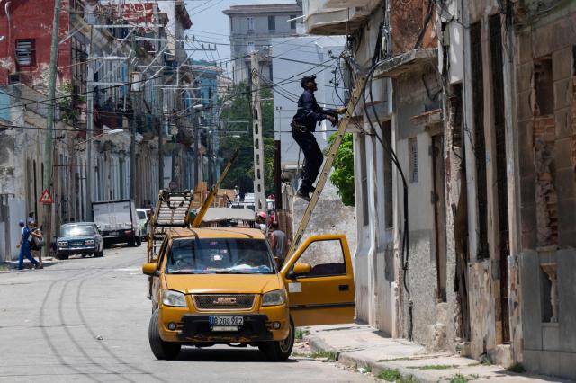 An electrician works on the power grid during a nationwide power outage in Havana on 6 July 2026. Cuba on July 6 suffered its third nationwide power outage since the start of the year, the state electricity company said. The impoverished island was already struggling to keep the lights on before US President Donald Trump in January imposed an oil blockade, which has depleted the already dwindling supply of fuel for Cuba's power plants. (Photo by YAMIL LAGE / AFP)