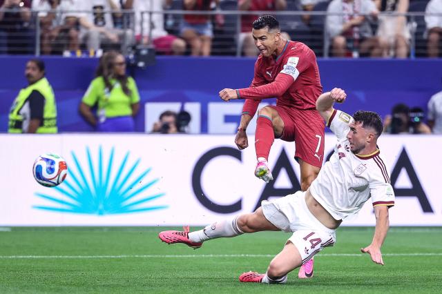 Portugal's forward #07 Cristiano Ronaldo kicks the ball and misses a chance pas Spain's defender #14 Aymeric Laporte during the 2026 World Cup round of 16 football match between Portugal and Spain at the Dallas Stadium in Arlington on July 6, 2026. (Photo by Thomas COEX / AFP)