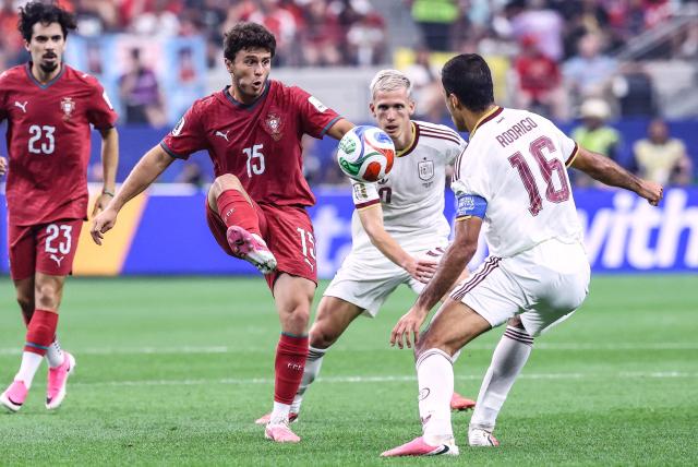 Portugal's midfielder #15 Joao Neves kicks the ball past Spain's forward #10 Dani Olmo and midfielder #16 Rodri during the 2026 World Cup round of 16 football match between Portugal and Spain at the Dallas Stadium in Arlington on July 6, 2026. (Photo by Thomas COEX / AFP)